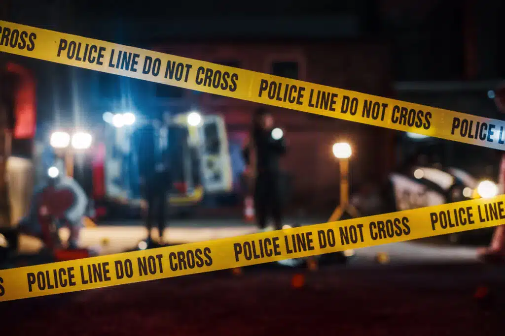 Police crime scene tape in front of a crime scene, representing the 2023 drop in homicides.