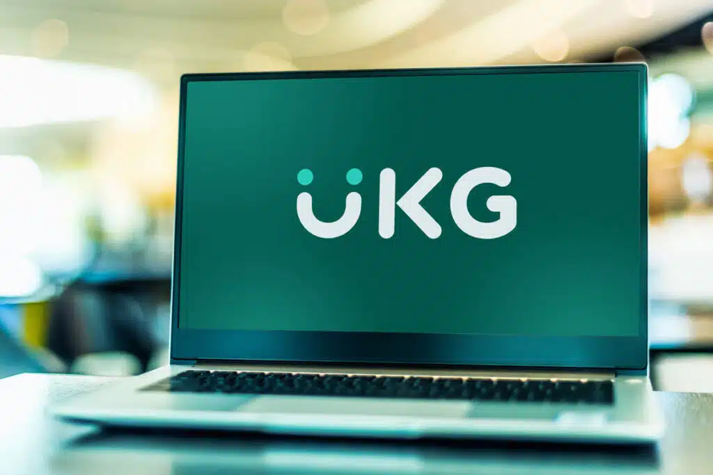 UKG logo displayed on a laptop screen, representing the UKG Kronos data breach class action lawsuit settlement.