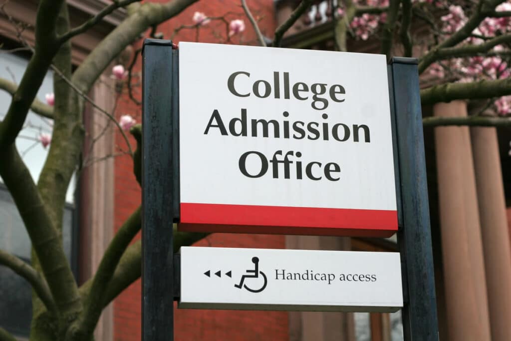 Close up of College Admission Office signage, representing Wesleyan University legacy admissions.