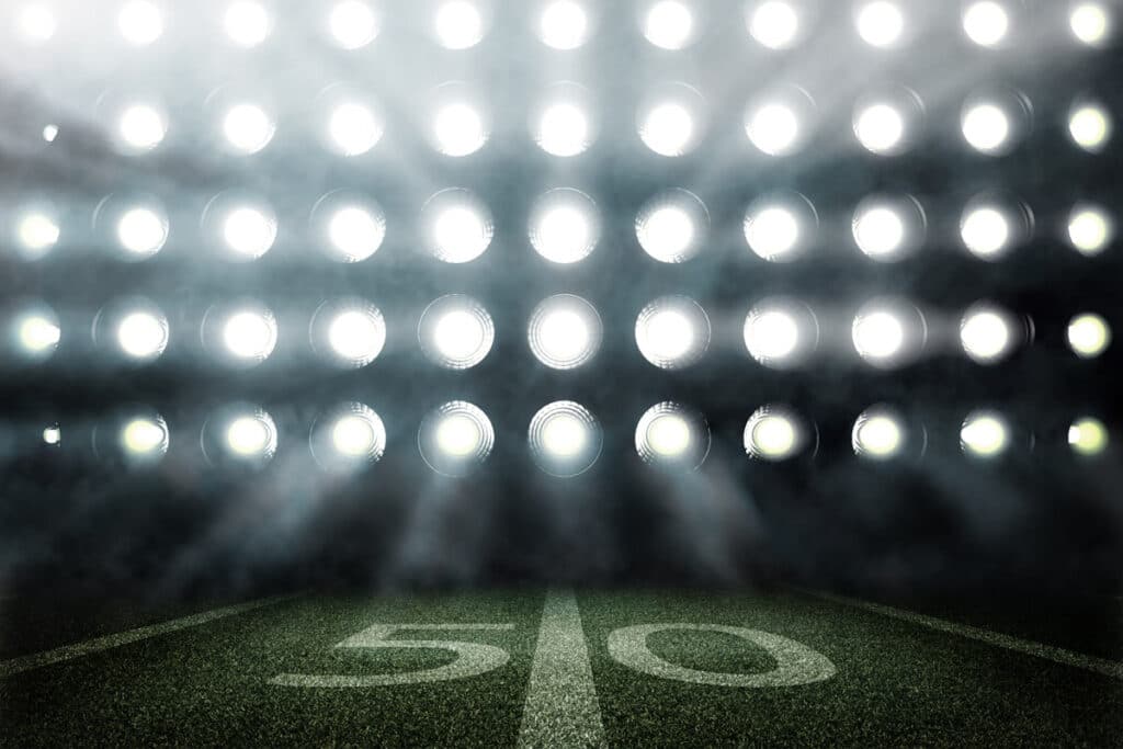 Bright stadium light on a playing field, representing recent sports lawsuits.