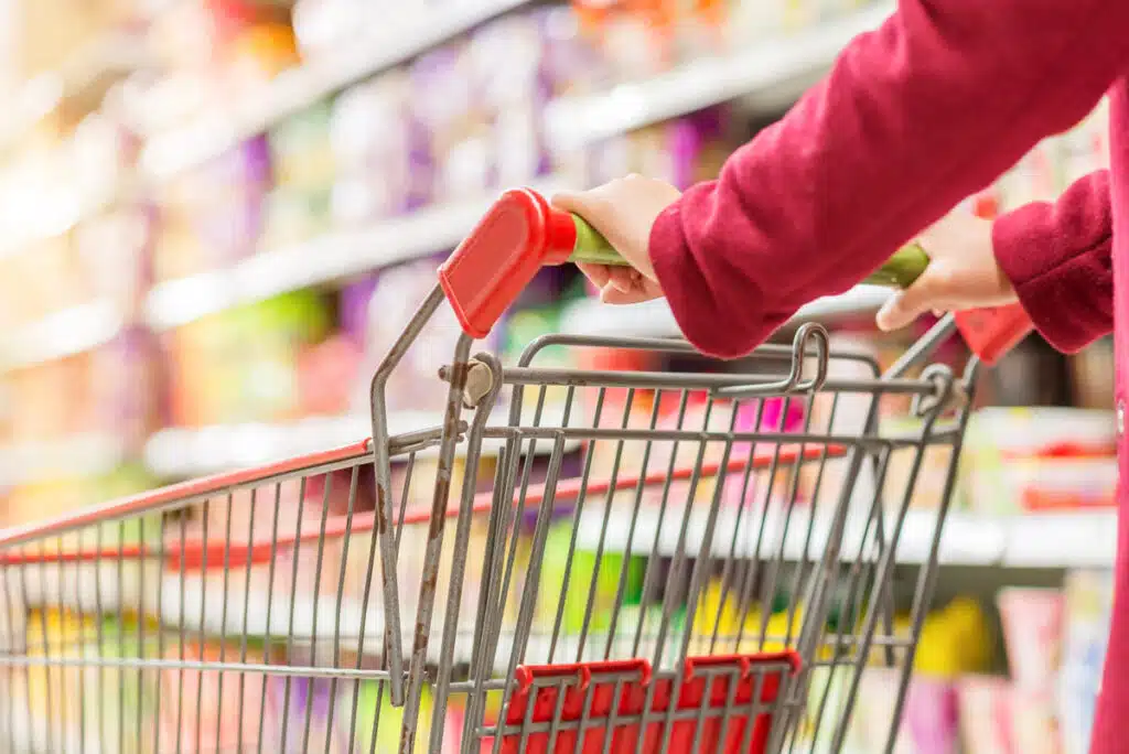 Close up of a shopping cart being pushed, representing top recalls for the week of July 10.