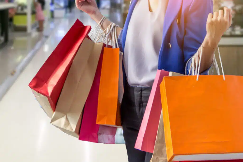 Close up of a woman holding shopping bags, representing top recalls for the week of July 17.