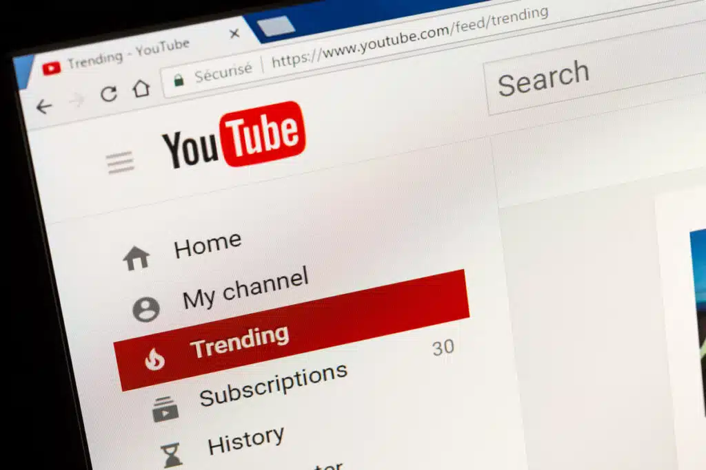 YouTube homepage displayed on a laptop screen, representing the FTX disaster class action lawsuit. YouTube star Brian Jung is facing a $1 billion class action lawsuit for allegedly promoting the sale of FTX yield-bearing accounts without disclosing in any of his YouTube or social media posts that he was paid by FTX.