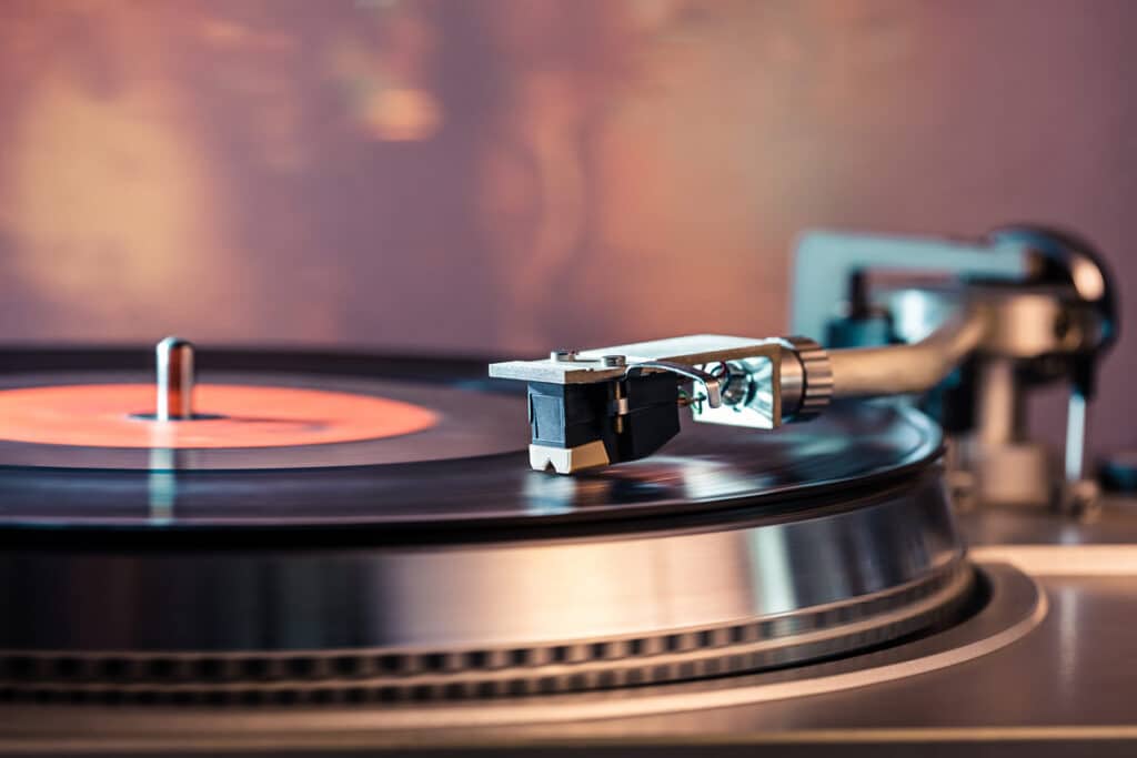 Close up of a vinyl playing on a record player, representing the Audiophile Music Direct "analog-only" class action lawsuit settlement.