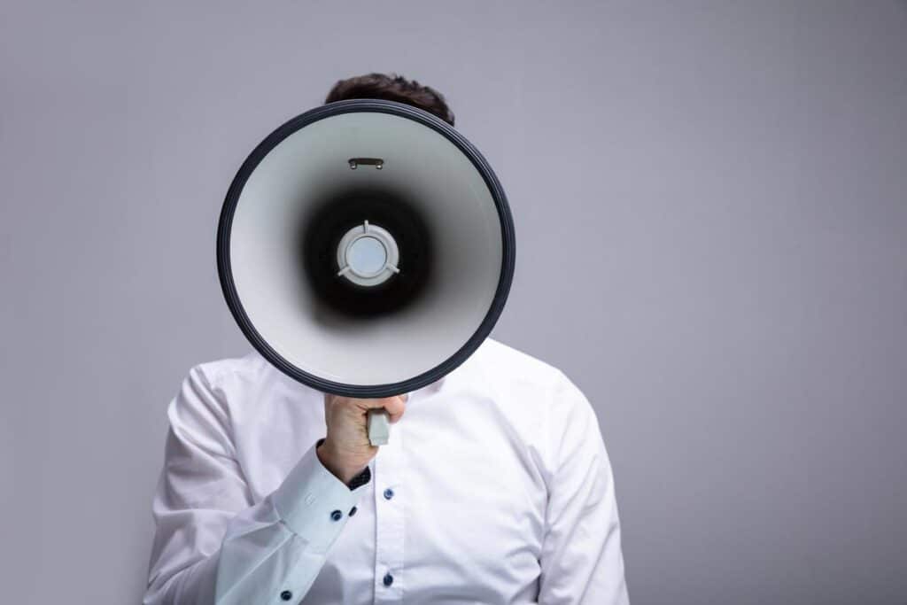 A man using a megaphone, representing top recalls for the week of Aug. 14.