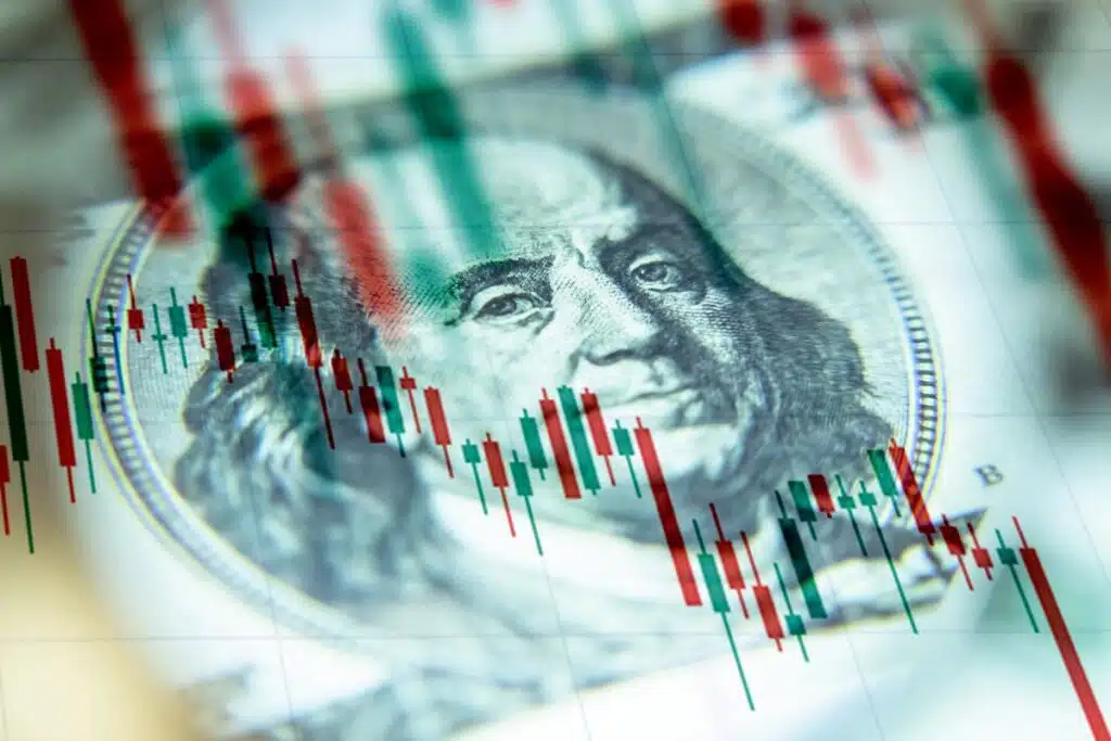 Close up of a money bill, with a declining chart overlay, representing AI threats.