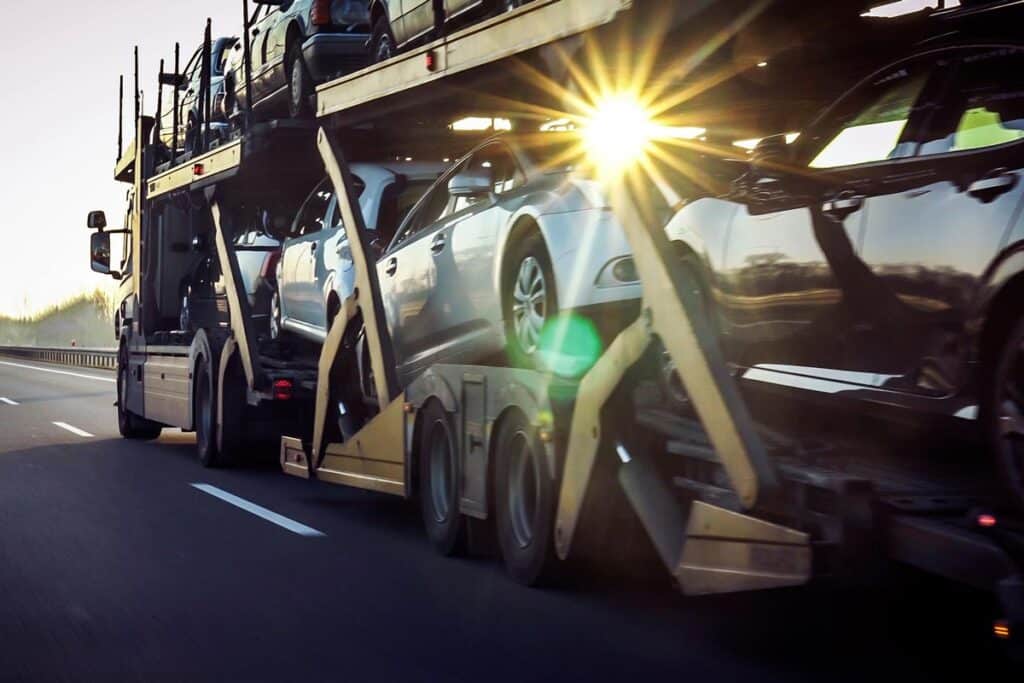 New cars being transported, representing the Peddle class action.