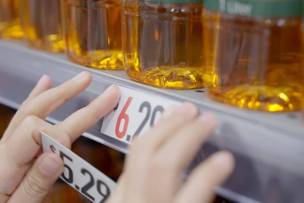 Close up of a price tag being changed, representing recent false advertising class action lawsuits and settlements.