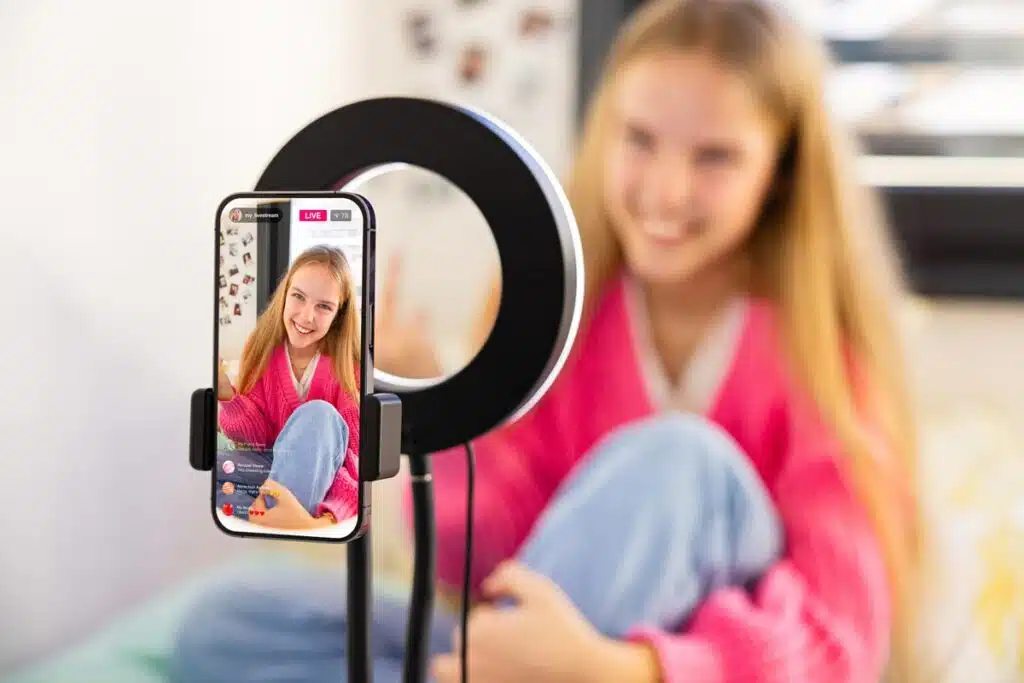A young girl live streaming, representing the new child influencer compensation law.