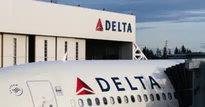 Delta logo seen on hanger and plane, representing the Delta Air Lines settlement.