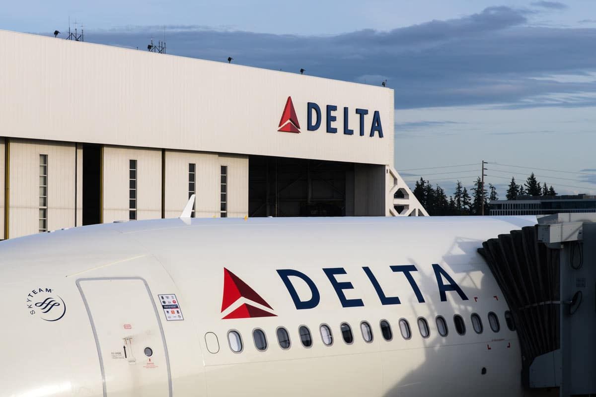 Delta logo seen on hanger and plane, representing the Delta Air Lines settlement.