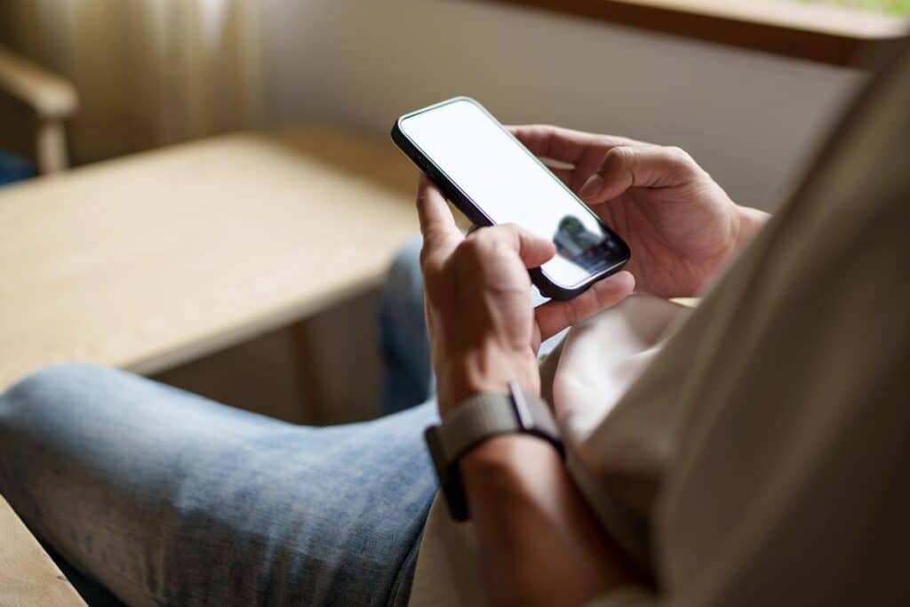 Close up of a man using his smartphone, representing the AI images ruling.