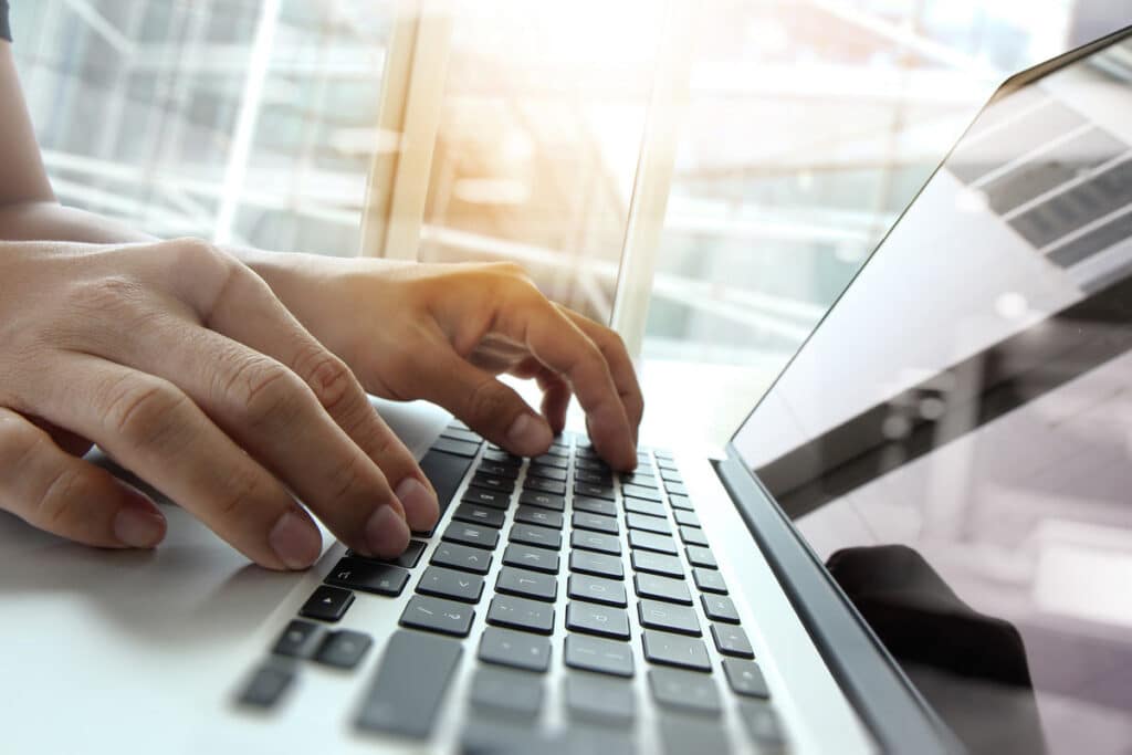Close up of a woman typing on a laptop, representing recent data privacy lawsuits.