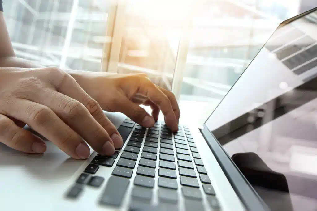 Close up of a woman typing on a laptop, representing recent data privacy lawsuits.