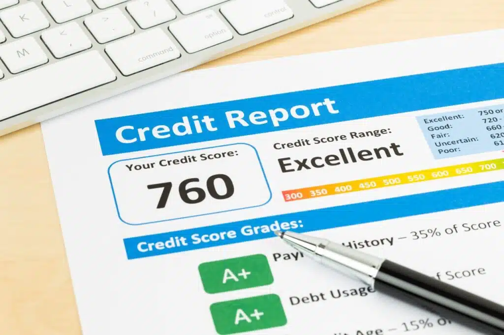 A credit report and pen are seen next to a keyboard on a desk, representing the Vivint home security FTC settlement.
