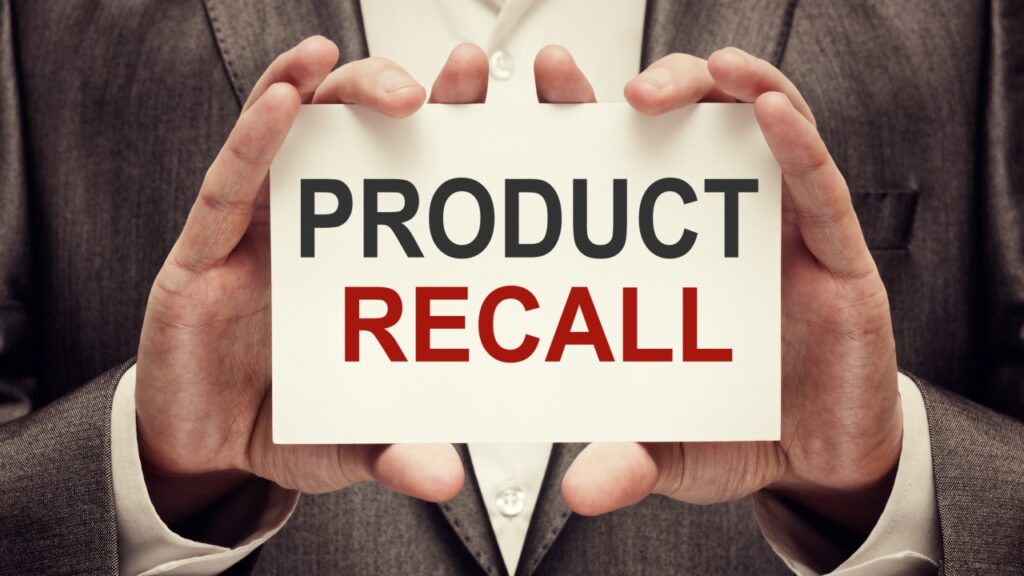 A man holds a card that says "Product recall," representing recent top recalls.