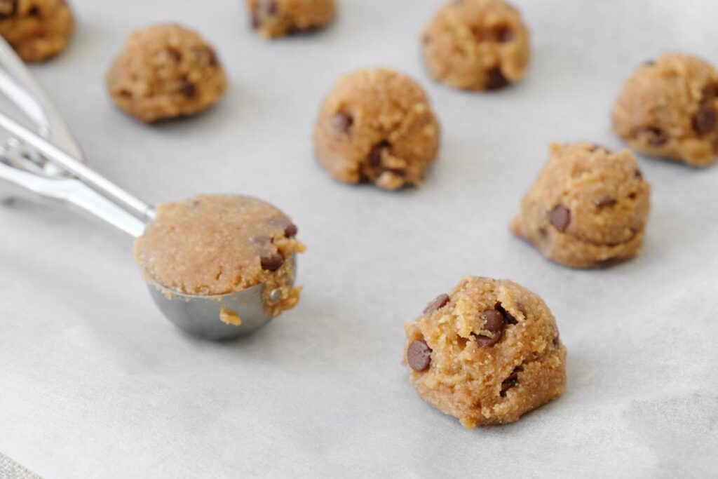 Close up of cookie dough balls on a cooking tray, representing the Nestle cookie dough recall.