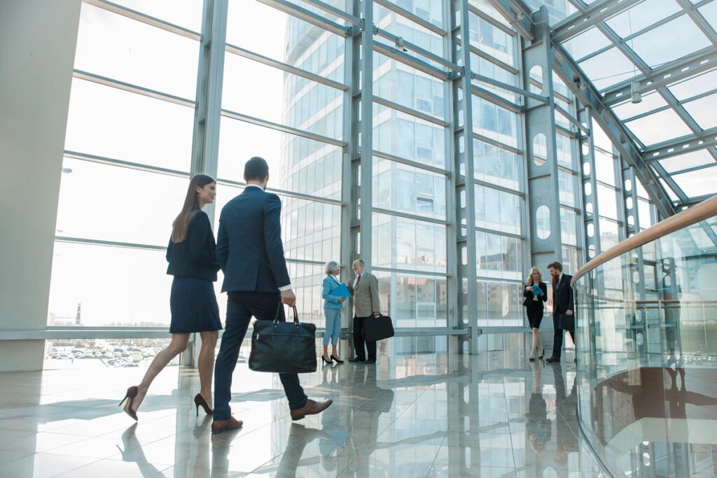Business people walking through an office building, representing employee class action lawsuits.