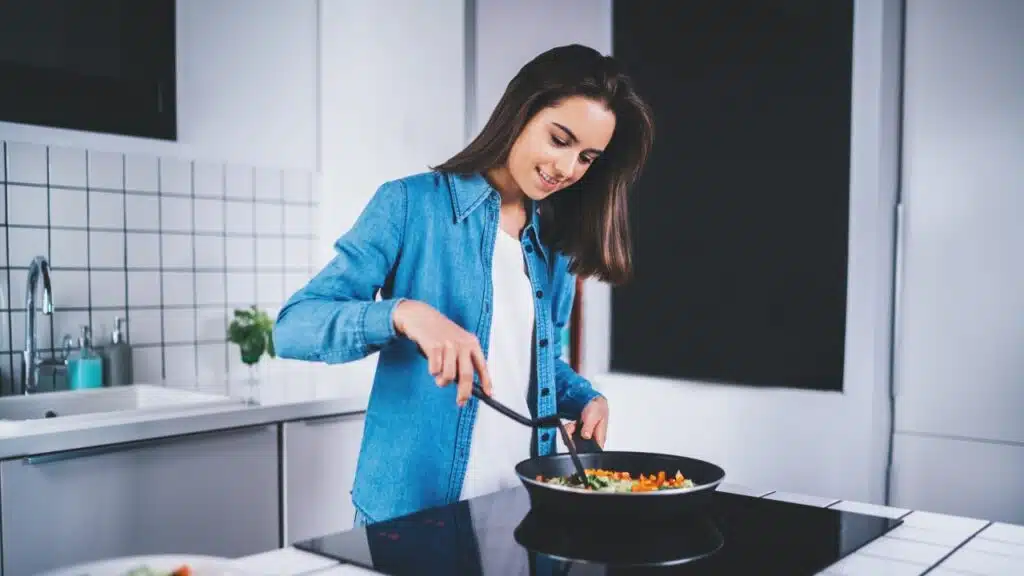 Woman using electric stove top