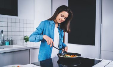 Woman using electric stove top