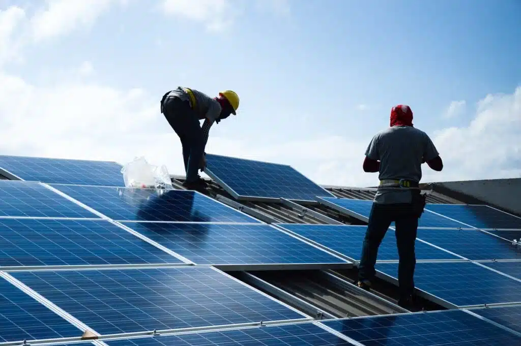 Workers installing solar panels on a house, representing the Better Earth class action.