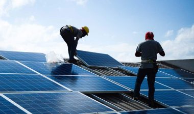 Workers installing solar panels on a house, representing the Better Earth class action.