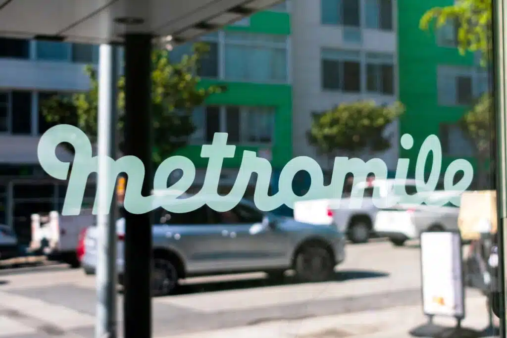 Close up of Metromile decal on a glass window, representing the Metromile data breach settlement.