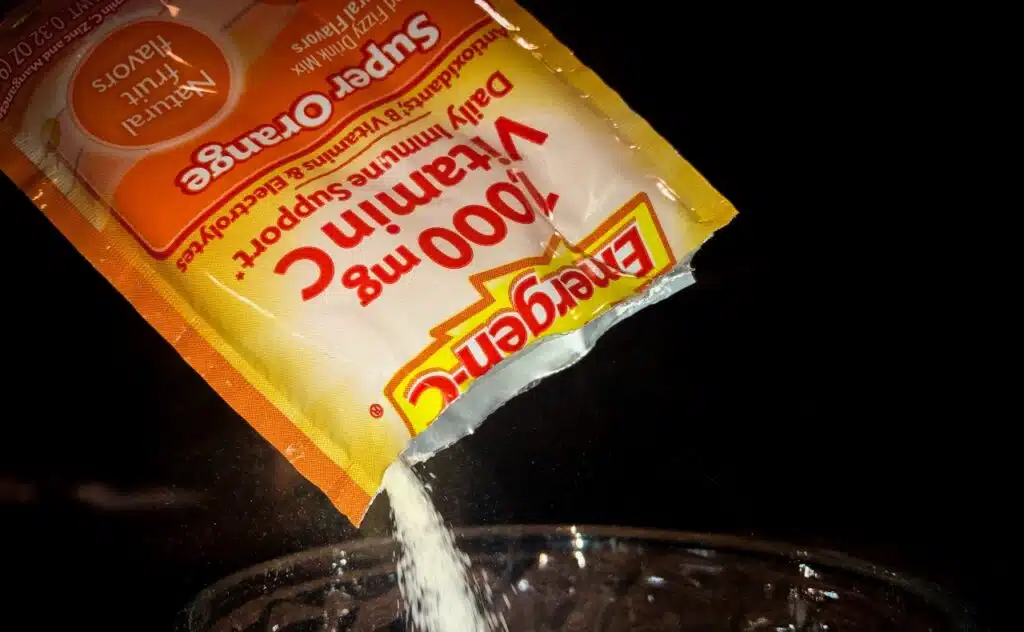 Open Emergen-C packed being poured into a glass of water