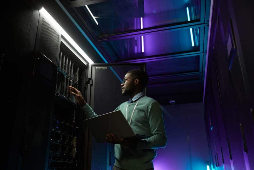 Technician working in a server room,  representing the Texas ENT data breach class action lawsuit settlement.