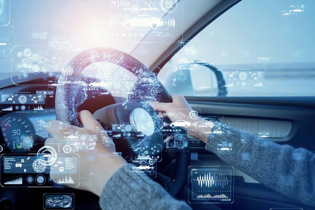 Close up of a persons hands on a steering wheel with a data concept overlay, representing the car data privacy study.