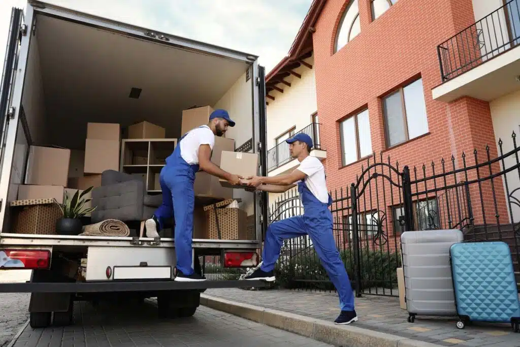 Workers from a moving company moving boxes, representing the moving companies class action.