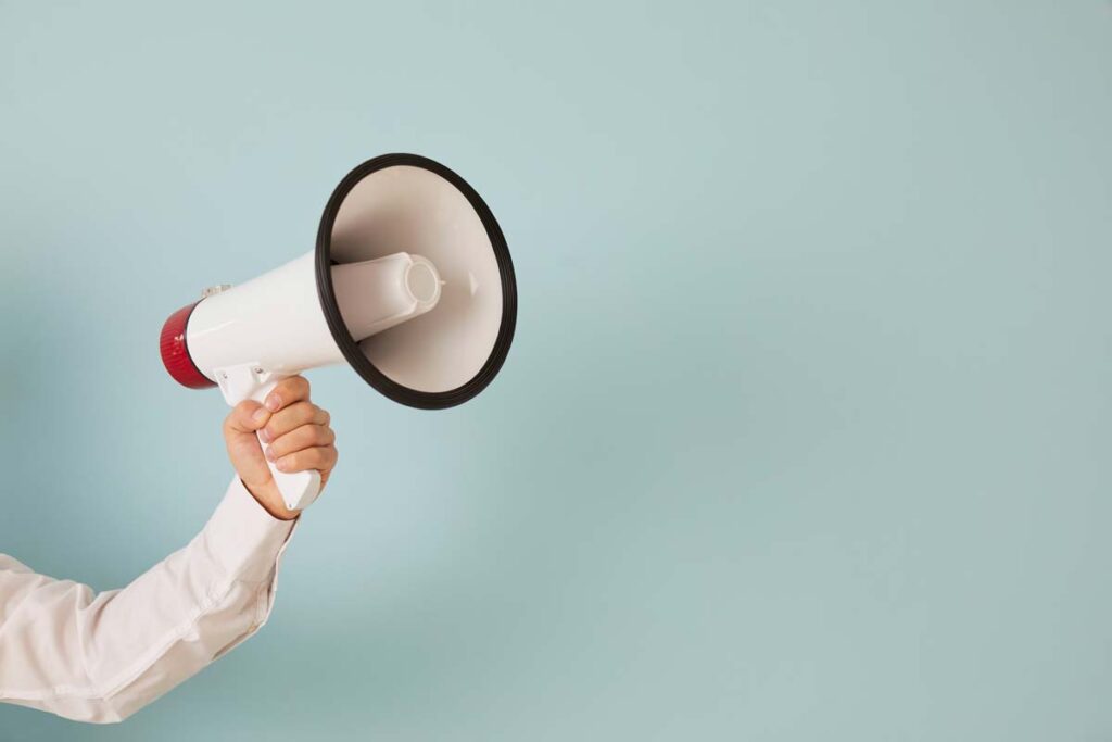 Close up of a person holding a megaphone, representing the top recalls for the week of Sept. 11.