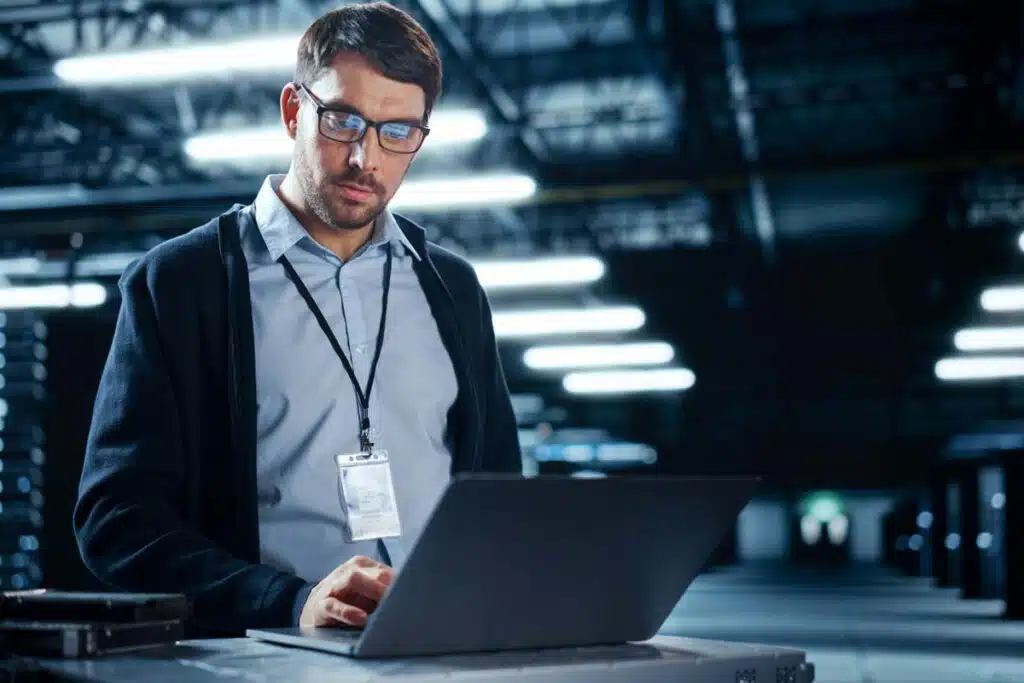IT worker working in a server room, representing the Cash Express data breach class action lawsuit settlement.