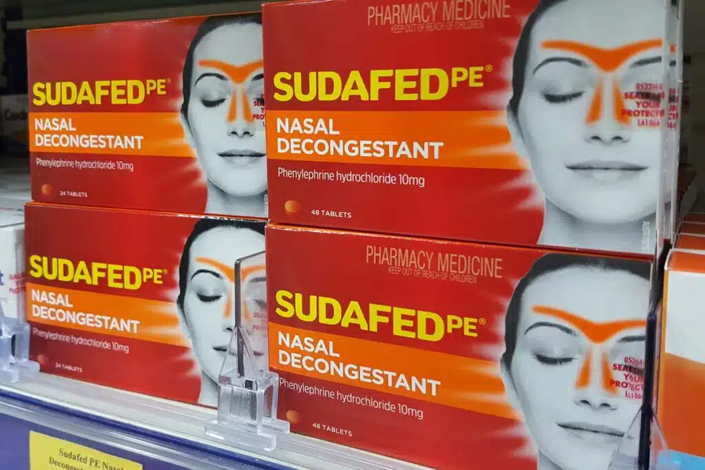 Close up of Sudafed PE boxes on a grocery store shelf, representing the Sudafed class action.