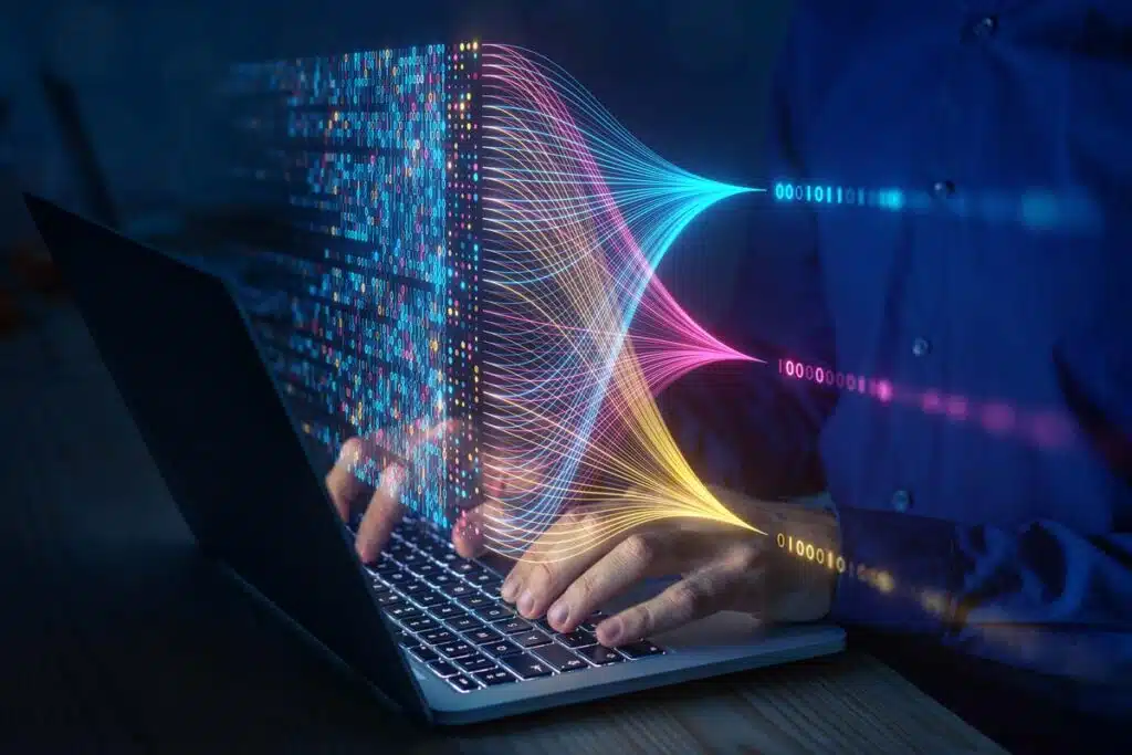 Close up of a person using a laptop with a data concept overlay, representing the CareCentrix and AMCA data breach class action lawsuit settlement.