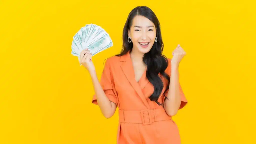 Happy woman with money in hand.