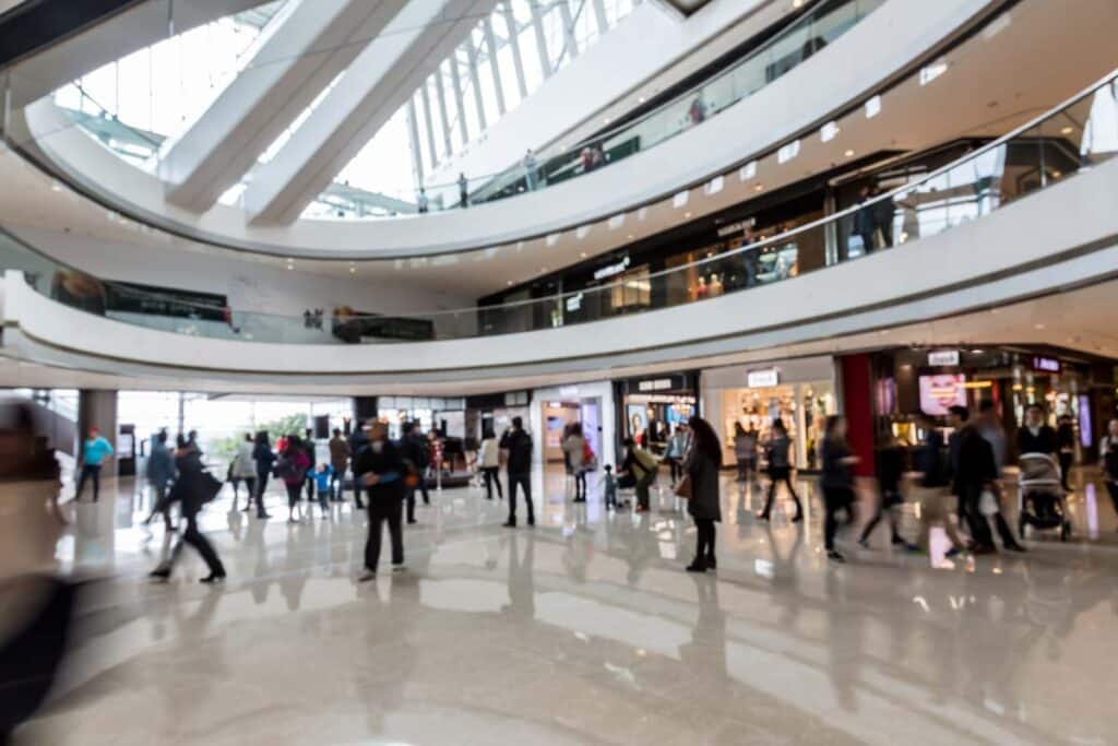 Inside a busy shopping mall, representing mall traffic.