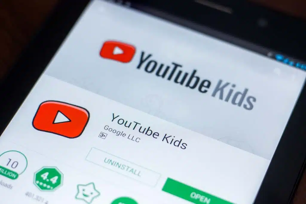 Close up of YouTube Kids app download page displayed on a smartphone screen, representing child data tracking.