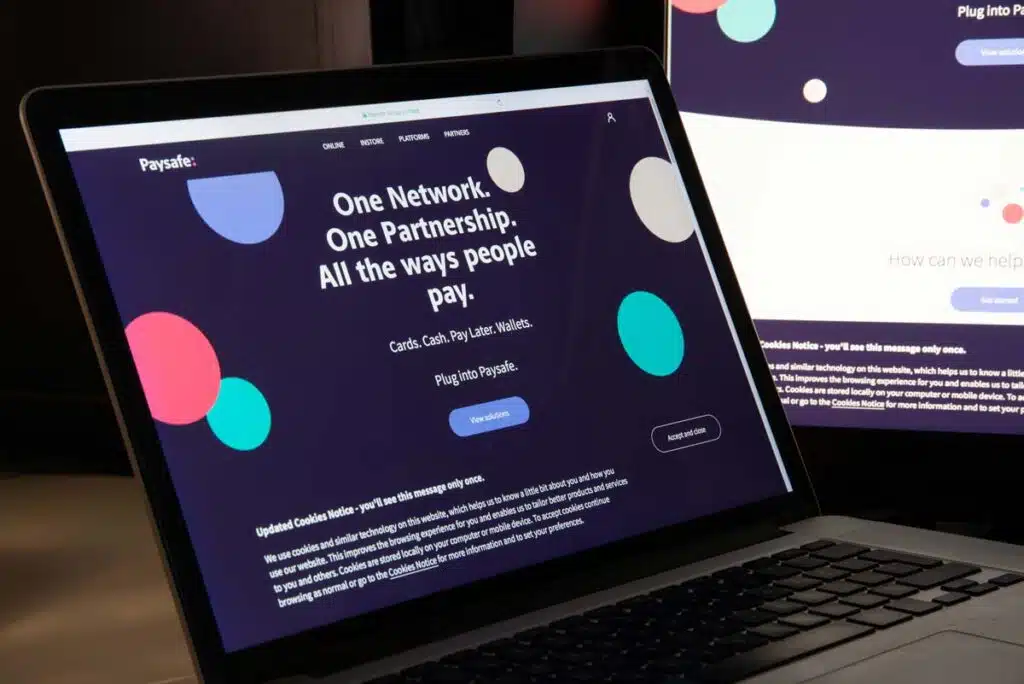 Paysafe website homepage displayed on a laptop screen, representing the Paysafe data breach class action settlement.