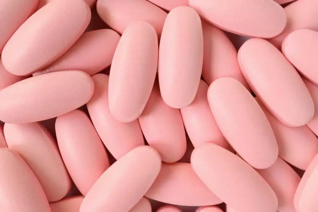 Close up of light pink pills, representing the Brexafemme recall.