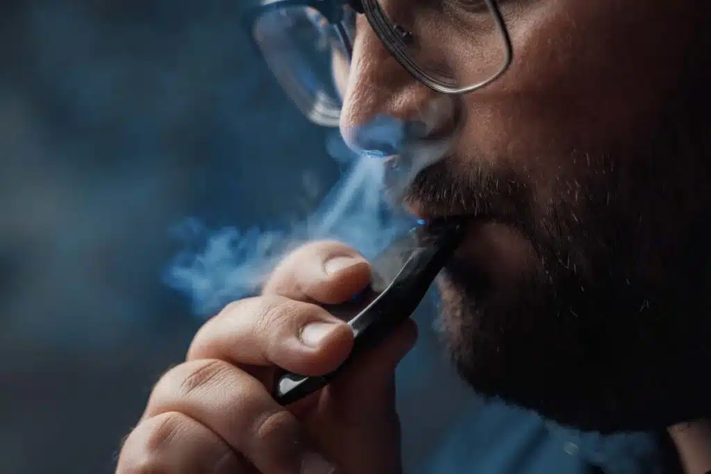 Close up of a man vaping, representing the Njoy illegal vape products lawsuit.