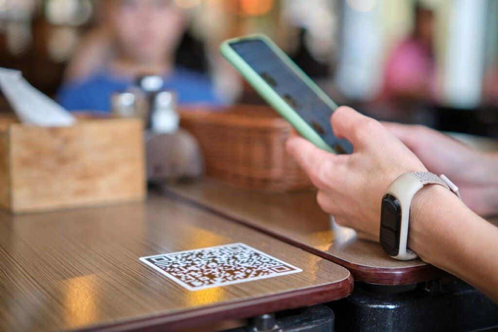 Close up of a hand placing a food mobile order on their smartphone, representing the Arby's and Burger King lawsuit.