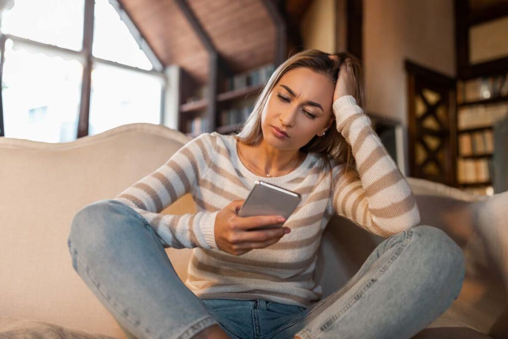 A young woman using her smartphone, representing the Premom app privacy settlement.
