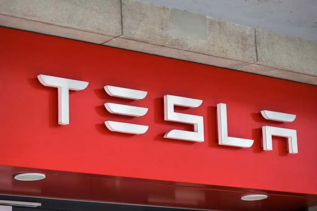 Close up of Tesla signage, representing the Tesla class action lawsuits and investigations.