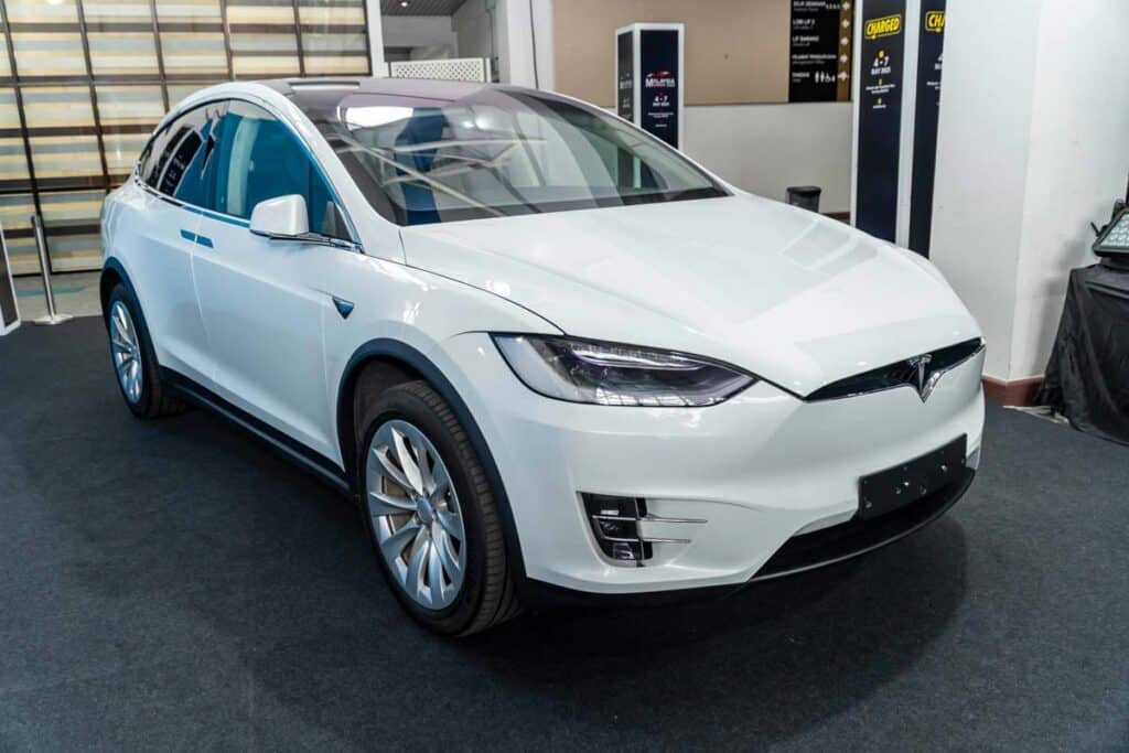 A white Tesla Model X at a car show, representing the Tesla Model X recall.
