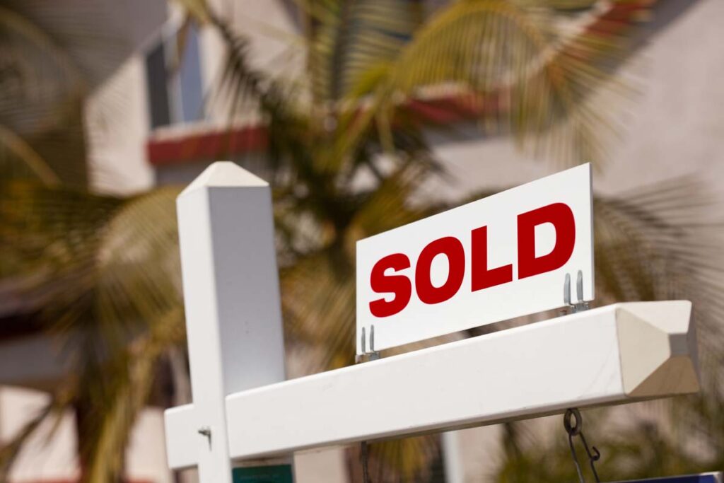 Close up of a sold sign outside of a residence, representing the Surety Title Co. class action lawsuit settlement.