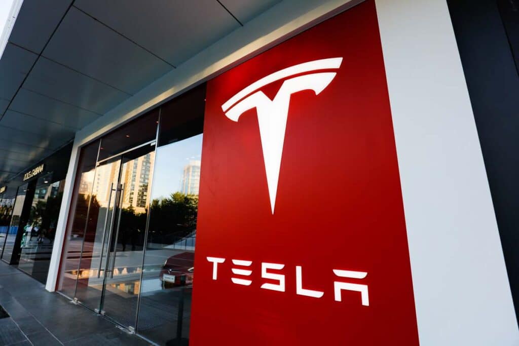 Close up of Tesla signage at an entrance, representing the Tesla Department of Justice probes.