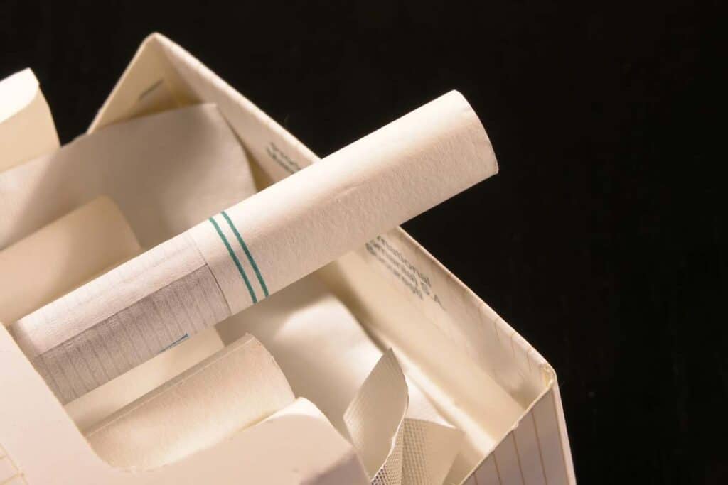 Close up of a menthol cigarette pulled out of a cigarette box, representing the proposed menthol cigarette ban.