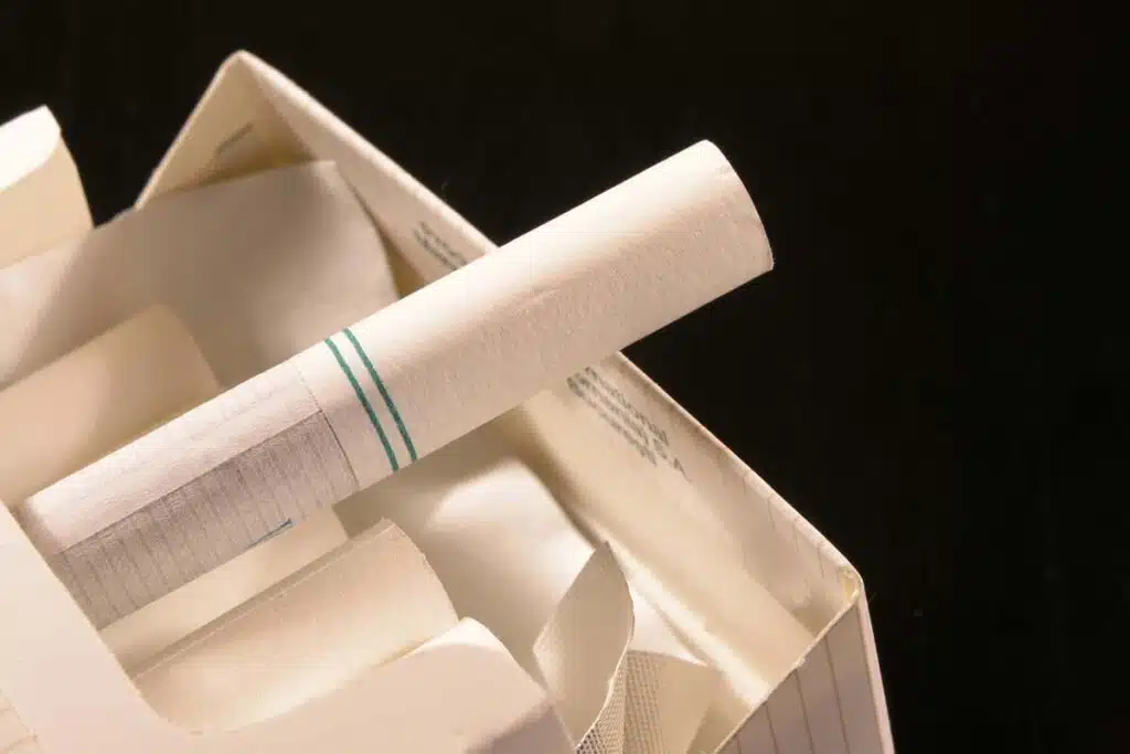Close up of a menthol cigarette pulled out of a cigarette box, representing the proposed menthol cigarette ban.