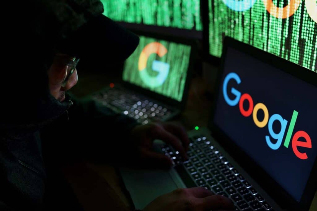 A scammer using a computer displaying the Google logo, representing the Google trademark lawsuit.